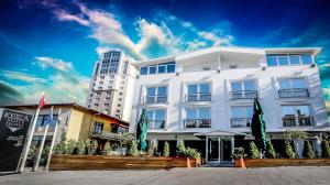 a white building in front of a tall building at Koza Suite Hotel in Ankara