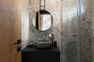 a bathroom with a sink and a mirror at Chapter 02 Gallery Suites in Heraklio +123 photos