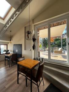 a dining room with a table and chairs and a large window at Admiramini B&B in Robbiate