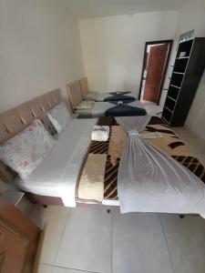 a large bed in a living room with at Pousada Sossego in Penha