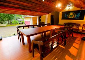 a dining room with a wooden table and chairs at Chandragiri Wayanad Traditional Bungalow by VOYE HOMES in Vaduvanchal
