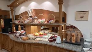 a kitchen with a counter with food on it at Hotel Garni Belvedere in Ischgl