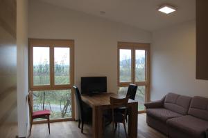 a living room with a table and a couch at Waldhof in Villach