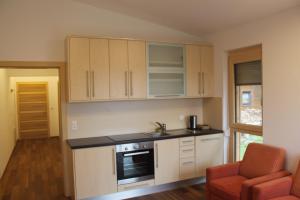 a kitchen with white cabinets and a stove at Waldhof in Villach