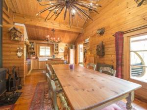 a dining room with a large wooden table in a cabin at Charming chalet in Durbuy near adventure valley in Durbuy +32 photos