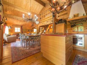 a kitchen and dining room with a table in a cabin at Charming chalet in Durbuy near adventure valley in Durbuy