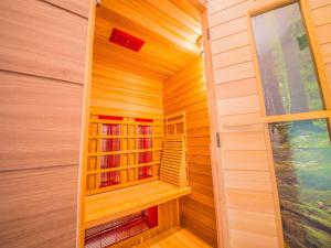 a sauna with wood paneling and a window at Mansion Ma Dame Jeanne in Durbuy with a sauna in Durbuy