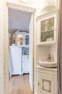 a bathroom with white cabinets and a sink at Guesthouse Delisa in Pärnu