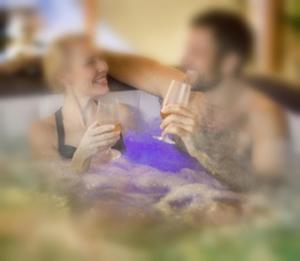 a man and woman sitting at a table drinking wine at Jacuzzi Massage sur rdv,Duo,reiki,californien, réflexologie plantaire, et bouteille mousseux offerte in Férolles +21 photos
