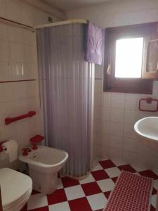 a bathroom with a toilet and a shower and a sink at Casa Rosalba in San Vito lo Capo