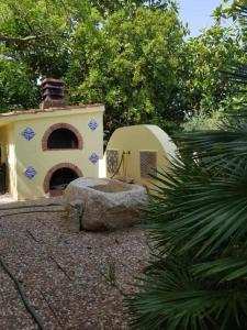 a building with a dome and a rock in a yard at Casa Rosalba in San Vito lo Capo +13 photos