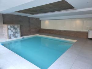 a large swimming pool with blue lighting in a room at Gran Hotel Dakar in Mendoza