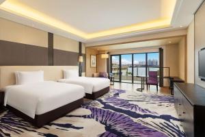 Voodi või voodid majutusasutuse Radisson Blu Hotel Wuhan ETD Zone toas