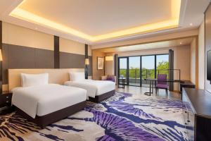 Voodi või voodid majutusasutuse Radisson Blu Hotel Wuhan ETD Zone toas