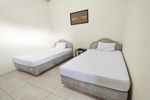 Ліжко або ліжка в номері OYO 91973 Green Hotel