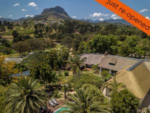 an aerial view of a house with mountains in the background at Africa Lodge in Somerset West