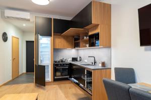 a kitchen with wooden cabinets and a counter top at TartuKodu Riia 20A-5 in Tartu