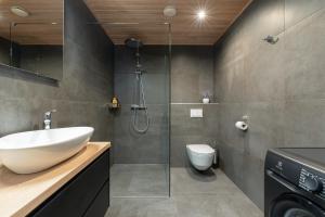 a bathroom with a shower and a sink and a toilet at TartuKodu Riia 20A-5 in Tartu +14 photos