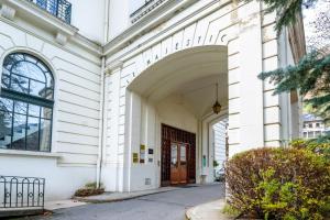 einen Eingang zu einem weißen Gebäude mit einer braunen Tür in der Unterkunft Majestic Alpin - A luxurious apartment with a nordic feel in Chamonix-Mont-Blanc