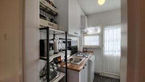 a small kitchen with a sink and a stove at Flat with Bosphorus view in Rumelihisarı in Istanbul