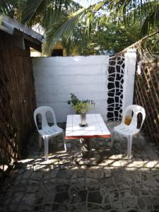 a patio with two chairs and a table and a table and chairs at LindenApartment 