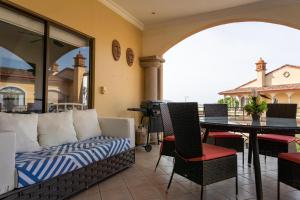 a living room with a couch and a table at Sunrise 12- 2 Bedroom Ocean View penthouse in Tamarindo