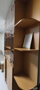 a room with a book shelf with a laptop on it at Бухар жырау 45 in Karagandy