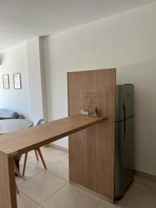 a kitchen with a table and a refrigerator at Departamento de 1 dormitorio - Zona parque independencia in Rosario