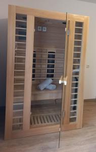 a wooden cabinet with glass doors in a room at Apartment Steirawohnzimmer in Haus im Ennstal