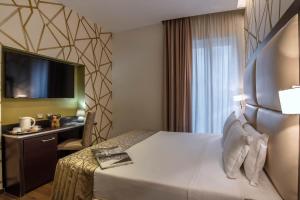 Postel nebo postele na pokoji v ubytování Catone District Hotel