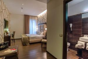 Postel nebo postele na pokoji v ubytování Catone District Hotel