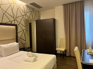 Postel nebo postele na pokoji v ubytování Catone District Hotel