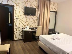 Postel nebo postele na pokoji v ubytování Catone District Hotel