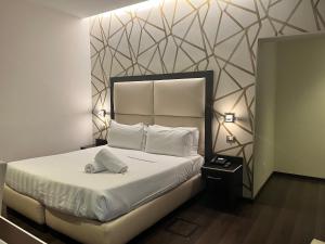 Postel nebo postele na pokoji v ubytování Catone District Hotel