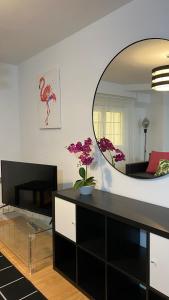 a living room with a large mirror on the wall at LC Apartamentos César Augusto in Zaragoza