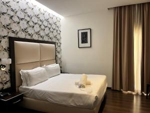 Postel nebo postele na pokoji v ubytování Catone District Hotel