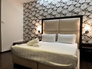 Postel nebo postele na pokoji v ubytování Catone District Hotel