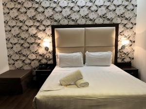 Postel nebo postele na pokoji v ubytování Catone District Hotel