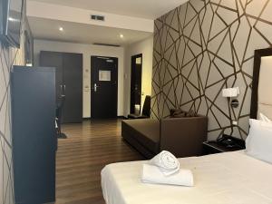 Postel nebo postele na pokoji v ubytování Catone District Hotel