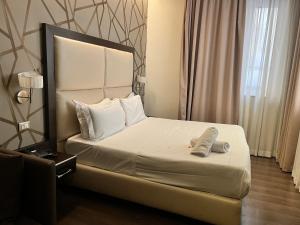 Postel nebo postele na pokoji v ubytování Catone District Hotel
