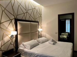 Postel nebo postele na pokoji v ubytování Catone District Hotel
