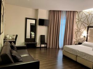 Postel nebo postele na pokoji v ubytování Catone District Hotel