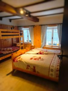 een slaapkamer met 2 stapelbedden en 2 ramen bij MolinDeiMaghi in Fondo