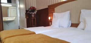 Postel nebo postele na pokoji v ubytování Hotel Okresní Dům
