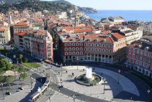 an aerial view of a city with buildings and a fountain at Samourai Massena Lodge -1 min from the sea in Nice