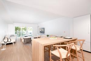 a kitchen and dining room with a wooden table and chairs at Beach Haus Residences in Bal Harbour