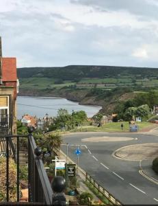 a view of a road and a body of water at The Wayfarer, Robin Hoods Bay in Whitby