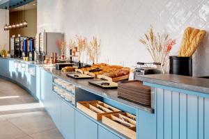 a bakery with a counter with bread on it at B&B HOTEL Lille Lillenium Eurasanté in Lille