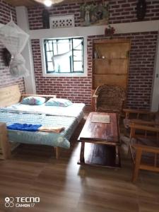 a bedroom with a bed and a table in it at Stany's apartments in Butare