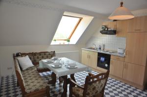 a kitchen with a table and chairs and a window at Ferienwohnung Landliebe 65347 in Moormerland